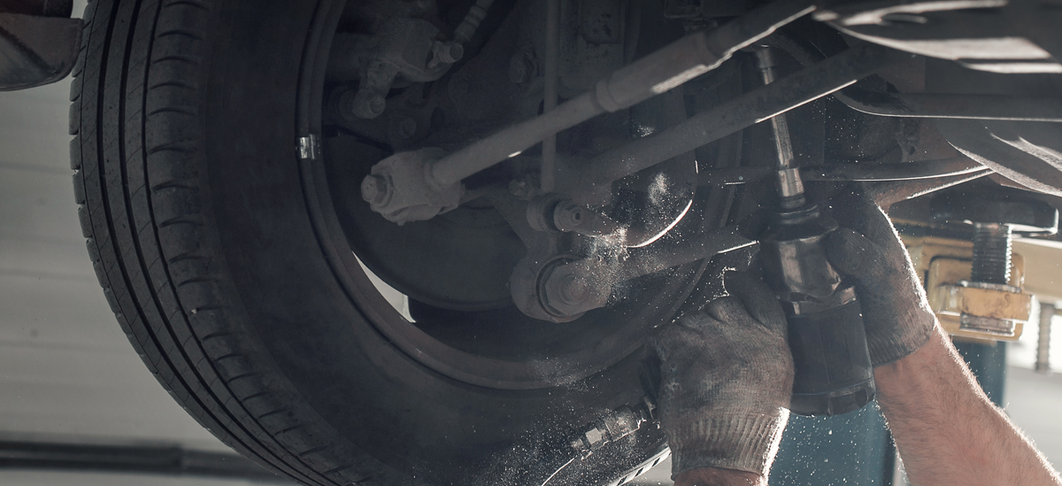 Mechanic under a vehicle - Car Suspension Saltcoats